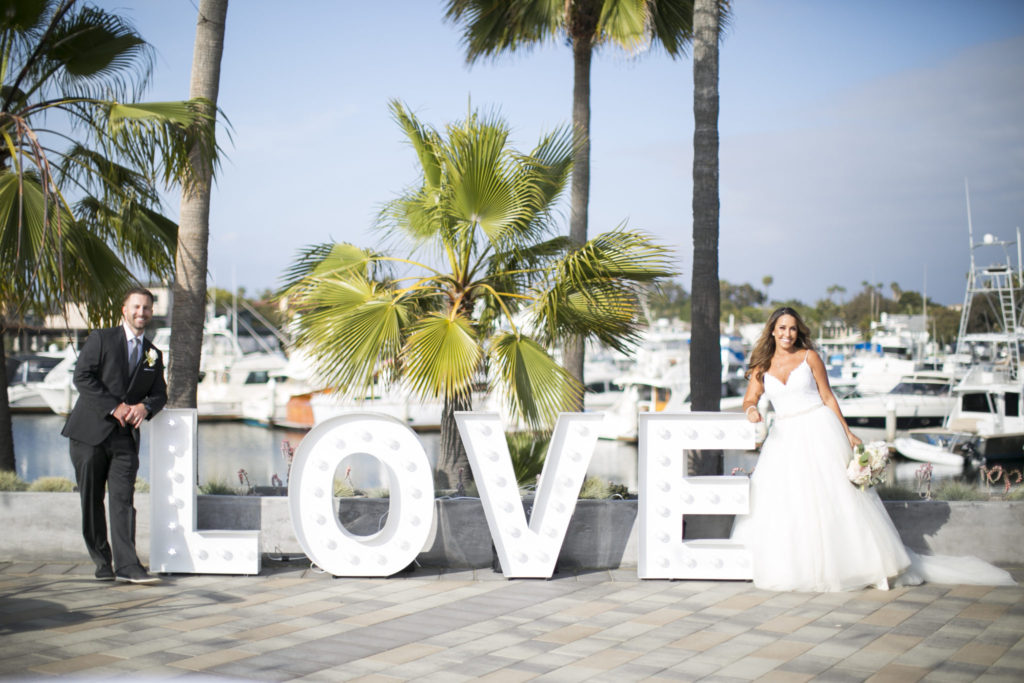 bride and groom, harbor wedding, love sign, floral design, florist, wedding florist, wedding flowers, orange county weddings, orange county wedding florist, orange county florist, orange county floral design, flowers by cina